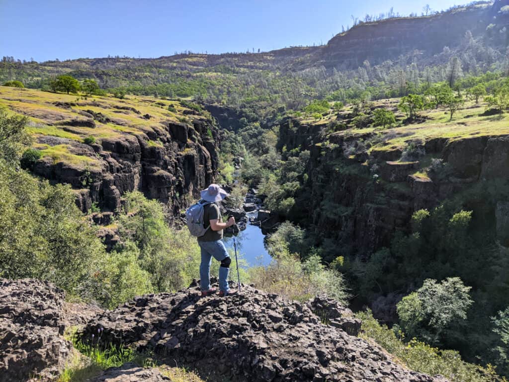 A man stands on the Yahi Trail overlooking Salmon Hole in Upper Bidwell Park