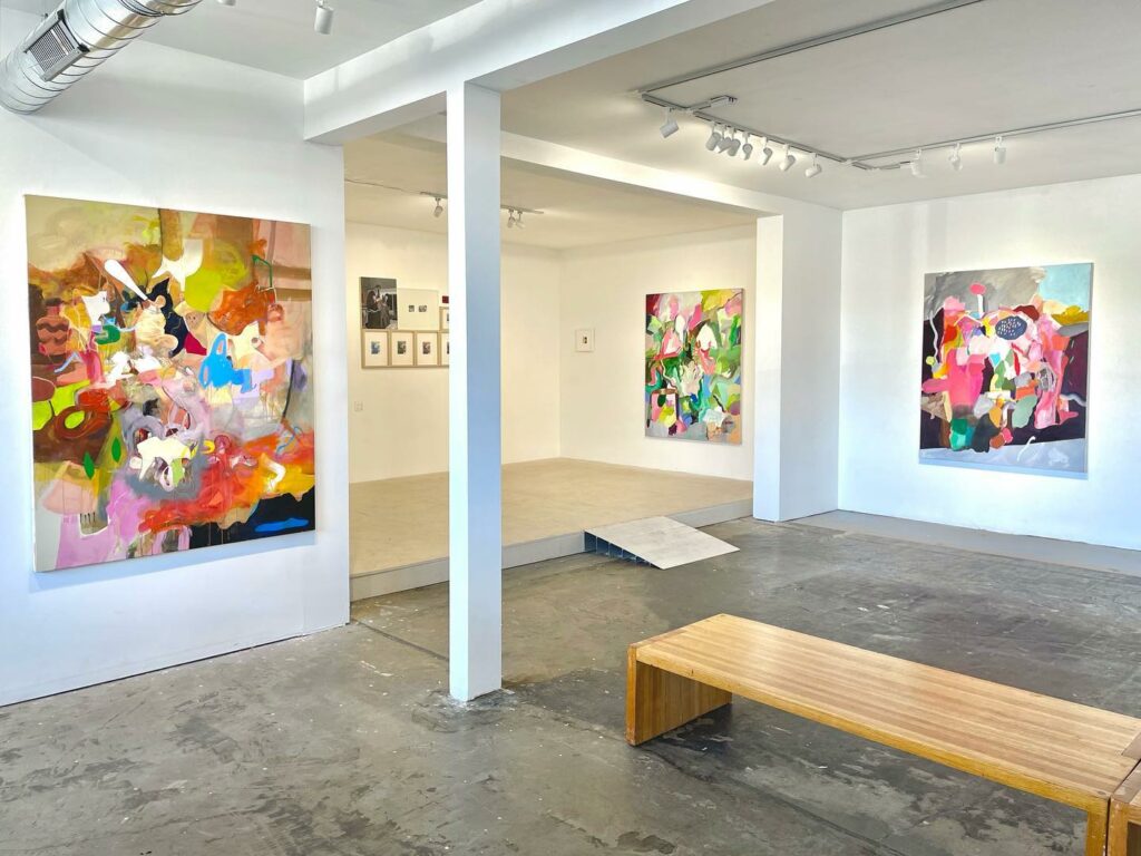 Interior of the 1078 Gallery in Chico, with 3 colorful large-format paintings hanging