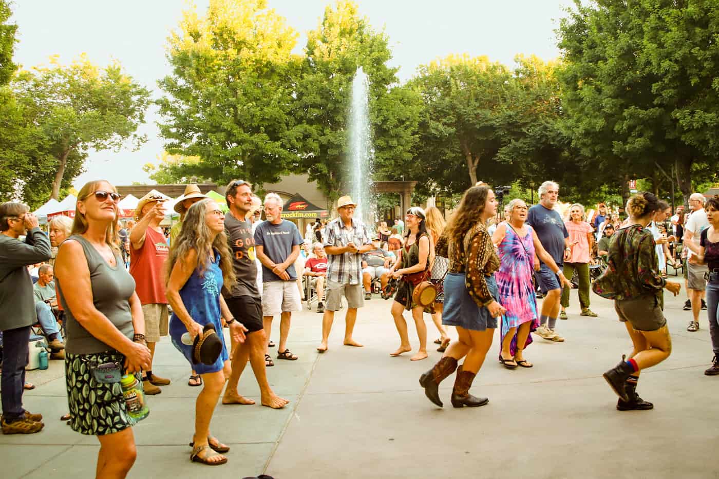 A crowd of people dances in the Chico City Plaza during Friday Night Concerts