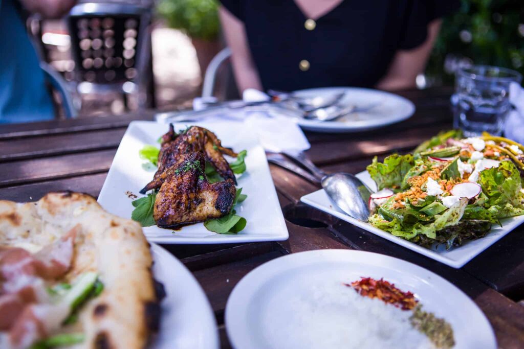 Several plates of food on an patio table at Grana in Chico