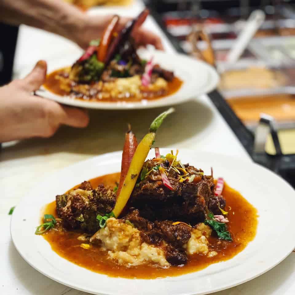 A close up of a well-plated meat dish at Burban Kitchen