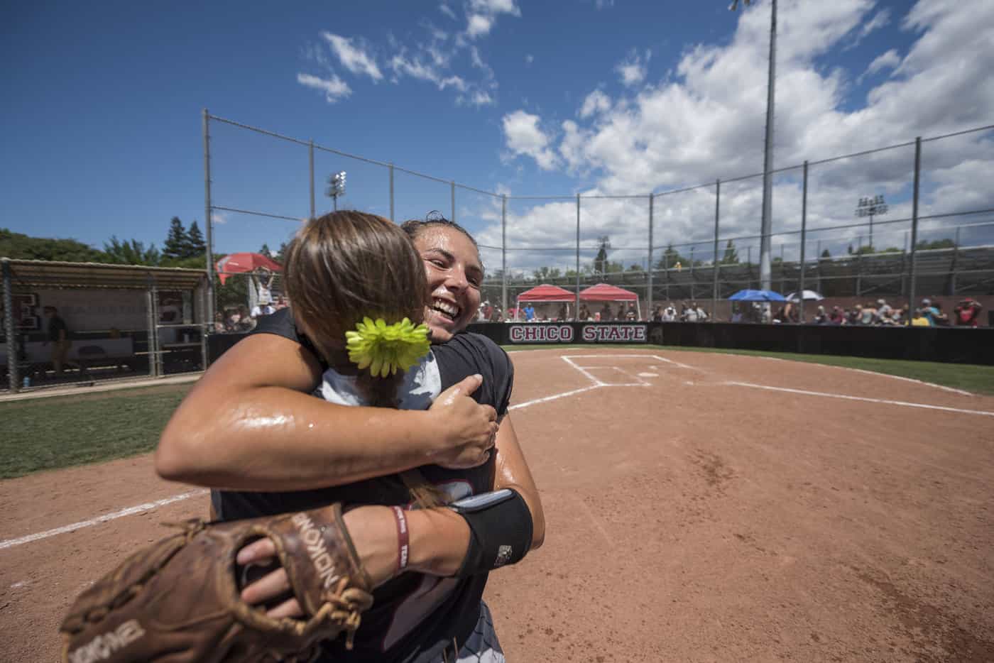 Two Chico State Softball players hugging (Jason Halley/CSU Chico)