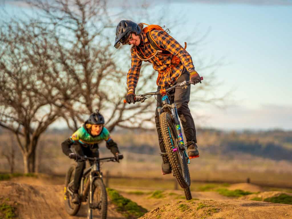 Two male teens mountain biking