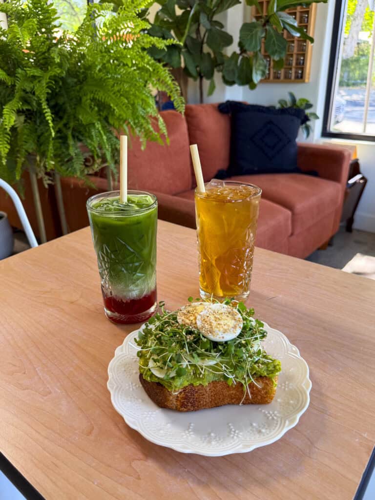 Chico Chai_2025-6-16_EDITED_0780_WEB An iced strawberry matcha and an iced tea behind an avocado toast with an egg at Chico Chai in Chico, California
